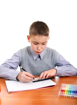 Cute Kid Drawing at the School Desk Isolated on the White Background