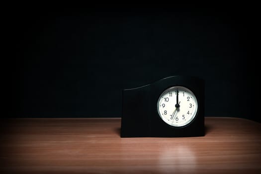 Clock in the Dark Room with display Almost Midnight