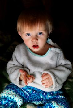 Surprised Baby Boy in the Dark Room