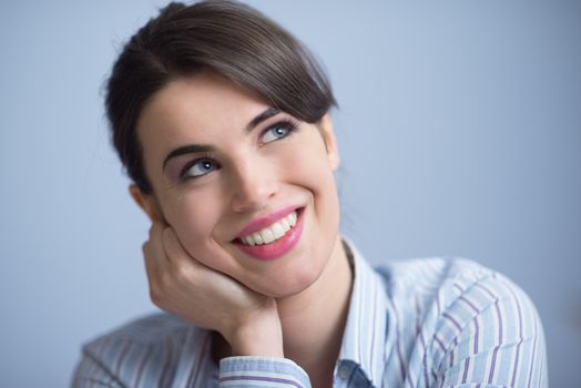 Attractive young woman smiling and looking up.