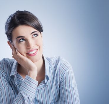 Attractive young woman smiling and looking up.