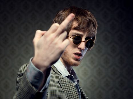 1960s style guy doing the fuck you sign