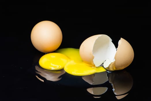 broken egg on a black background