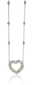 A beautiful diamond and gold heart pendant dangles from a chain. Fine Jewelry necklace isolated on a white background with shadow and reflection
