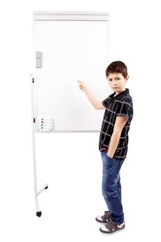young boy student in a classroom showing on a empty whiteboard