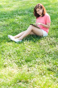 Happy Young Asian Woman Holding Digital Tablet and Smiling