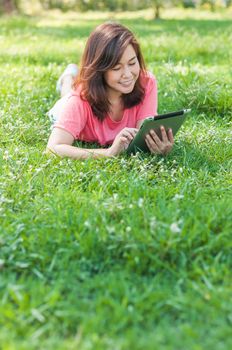 Happy Young Asian Woman Holding Digital Tablet and Smiling