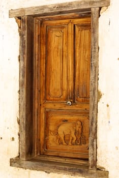 old wooden window that contain handcraft made of elephant figured,Lampang temple,Thailand