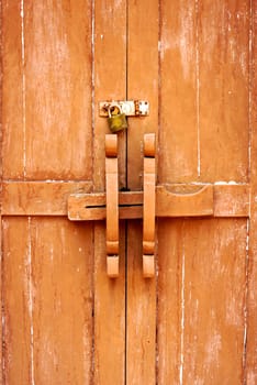 old style of thai wooden door that made handle and locking by wood