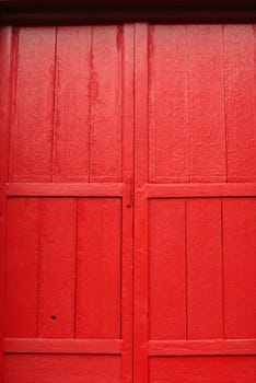 ancient wooden door that have very fine detail of thai pattern,shallow focus,Lampang temple,Thailand