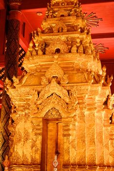 the high detail of square hall with pyramidal roof that made by real gold plate and decorated by craving thai pattern,Lampang temple,Thailand