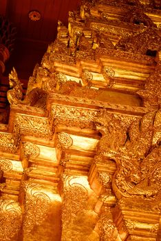 the high detail of square hall with pyramidal roof that made by real gold plate and decorated by craving thai pattern,Lampang temple,Thailand