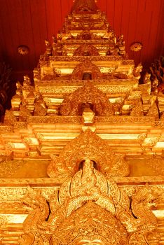 the high detail of square hall with pyramidal roof that made by real gold plate and decorated by craving thai pattern,Lampang temple,Thailand