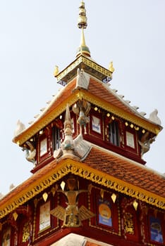 the detail of ancient thai decorated pattern that include handcraft wood carving work,gold painting and decorated with gold plate,mirror and precious stone,Lampang temple,Thailand