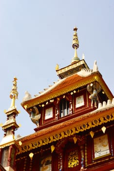 the detail of ancient thai decorated pattern that include handcraft wood carving work,gold painting and decorated with gold plate,mirror and precious stone,Lampang temple,Thailand