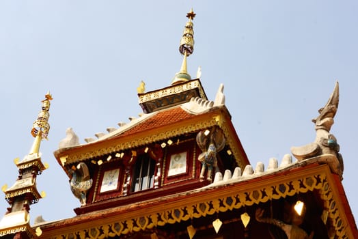 the detail of ancient thai decorated pattern that include handcraft wood carving work,gold painting and decorated with gold plate,mirror and precious stone,Lampang temple,Thailand