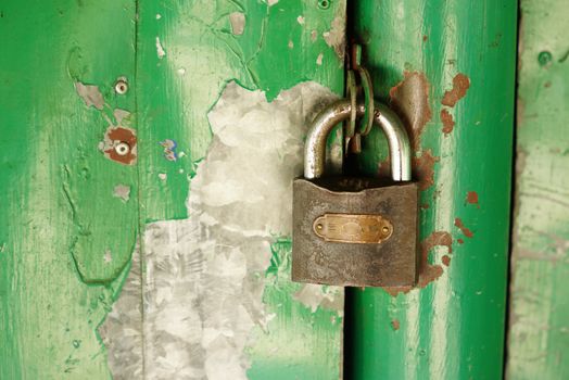 metal master key at wooden door,shallow focus