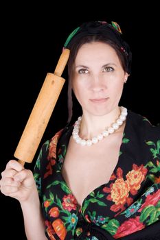 woman in a bandanna with a rolling pin in her hand on a black background