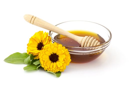 honey and calendula flowers on white background