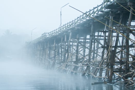 Wooden bridge with the fog in winter.