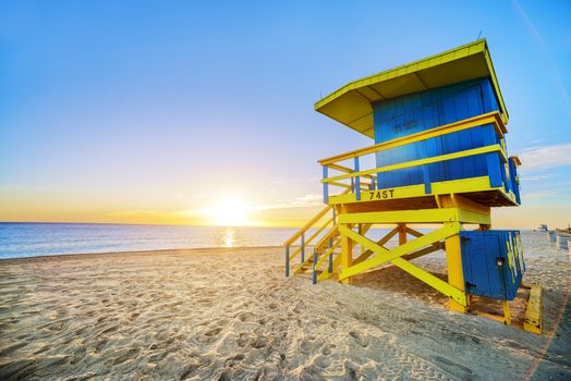 Miami South Beach sunrise with lifeguard tower and coastline with colorful cloud and blue sky. 