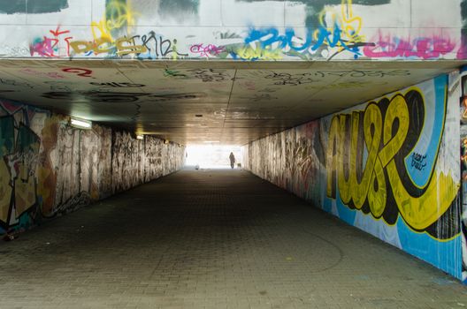 underground city crossing lighted lamps with abundant graffiti smeared walls