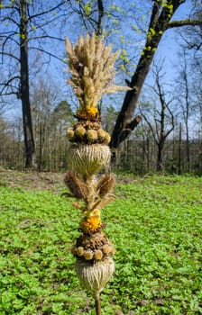 traditional spring festival palm composition from dry grass sedge flowers and branches garden in the background