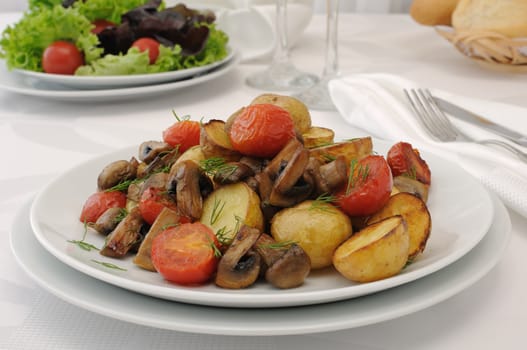 Fried mushrooms with sliced tomatoes and potatoes