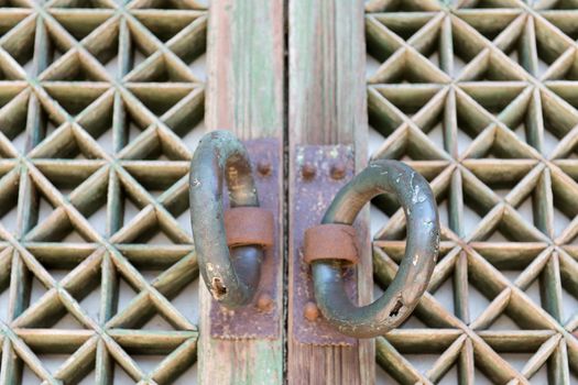 Detail of an old wooden door at a buddhist temple with door handles