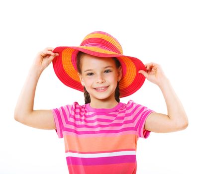Cute little girl wearing a beach hat smiling isolated on a white background.