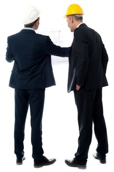 Two architects in a suit looking building plan