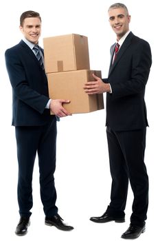 Two young businessmen holding cardboard boxes