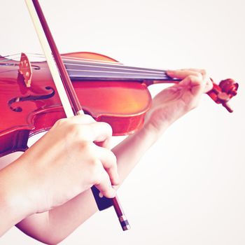 woman playing violin with retro filter effect
