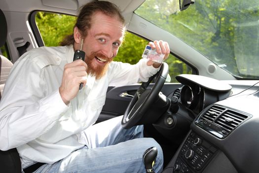 driver smiling sitting in car and showing new car keys and drivers license