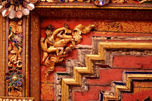 the detail of ancient thai decorated pattern that include handcraft wood carving work,gold painting and decorated with gold plate,mirror and precious stone,Lampang temple,Thailand
