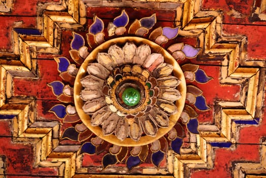 the detail of ancient thai decorated pattern that include handcraft wood carving work,gold painting and decorated with gold plate,mirror and precious stone,Lampang temple,Thailand