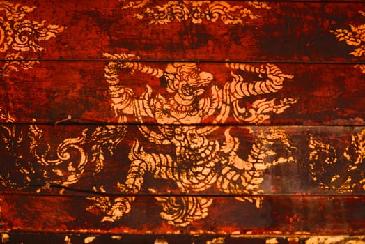 the detail of  thai gold painting pattern on ancient  wood plate,shallow focus,Lampang temple,Thailand