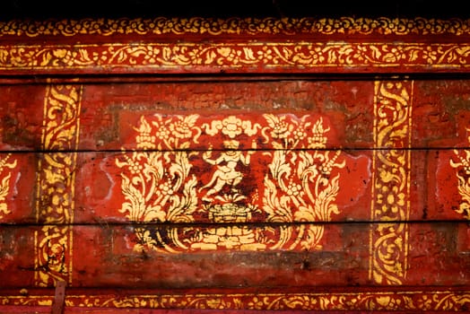 the detail of  thai gold painting pattern on ancient  wood plate,shallow focus,Lampang temple,Thailand