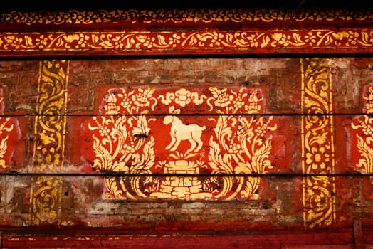 the detail of  thai gold painting pattern on ancient  wood plate,shallow focus,Lampang temple,Thailand