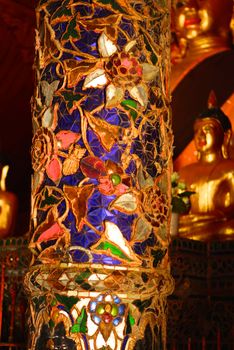 the detail of ancient thai decorated pattern that include handcraft wood carving work,gold painting and decorated with gold plate,mirror and precious stone,Lampang temple,Thailand