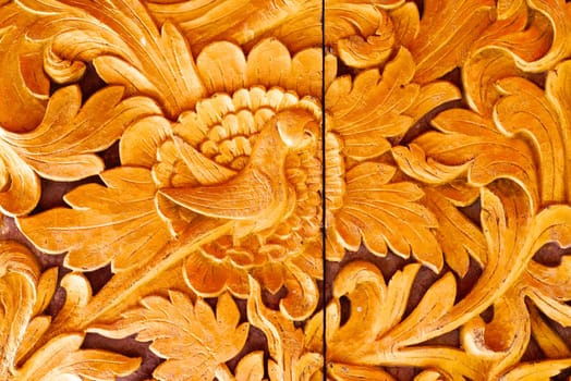 the detail of ancient thai decorated pattern that include handcraft wood carving work,gold painting and decorated with gold plate,mirror and precious stone,Lampang temple,Thailand