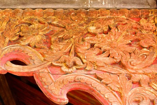 the detail of ancient thai decorated pattern that include handcraft wood carving work,gold painting and decorated with gold plate,mirror and precious stone,Lampang temple,Thailand