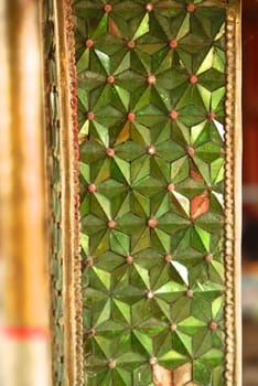 the detail of ancient thai art that include handcraft made of mirror and precious stone decorated ,wood carving,thai pattern gold painting and gold plate covered