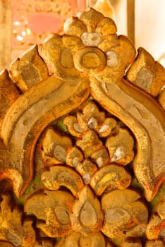 the detail of ancient thai decorated pattern that include handcraft wood carving work,gold painting and decorated with gold plate,mirror and precious stone,Lampang temple,Thailand