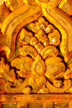 the detail of ancient thai decorated pattern that include handcraft wood carving work,gold painting and decorated with gold plate,mirror and precious stone,Lampang temple,Thailand