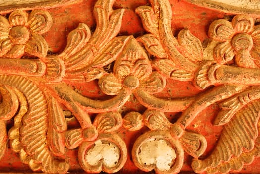 the detail of ancient thai decorated pattern that include handcraft wood carving work,gold painting and decorated with gold plate,mirror and precious stone,Lampang temple,Thailand