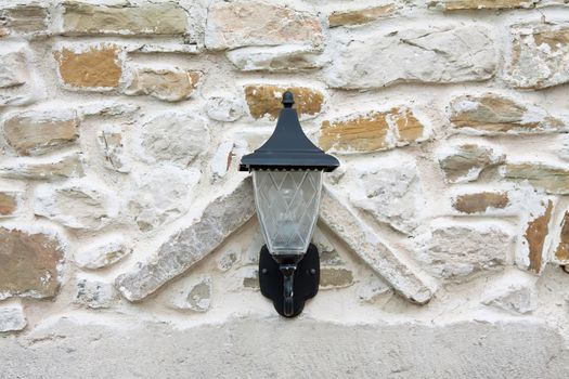 lantern lamp on the stone wall