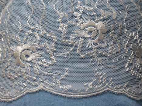 White lace band isolated over a light blue background
