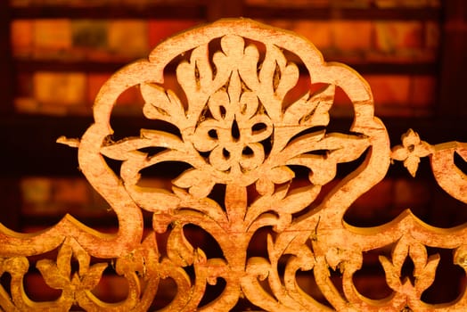 the detail of ancient thai decorated pattern that include handcraft wood carving work,gold painting and decorated with gold plate,mirror and precious stone,Lampang temple,Thailand