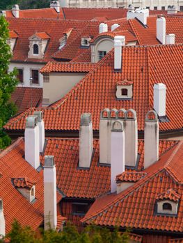 Typical Prague red rooftops with white chimneys